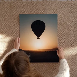 Gros plan sur les mains tenant le tirage d'art montrant la texture du papier mat épais.
